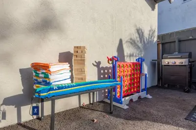 a blue bench sitting next to a wall with a grill at Modern Getaway Near Downtown – Family Friendly in San Diego