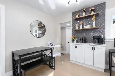 a dining room with a table and a mirror at Modern Getaway Near Downtown – Family Friendly in San Diego