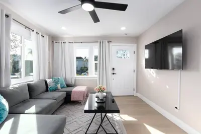 a living room with a couch and a ceiling fan at Modern Getaway Near Downtown – Family Friendly in San Diego