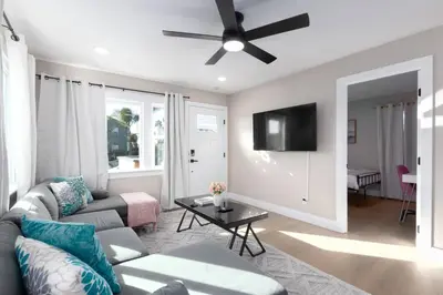 a living room with a couch and a ceiling fan at Modern Getaway Near Downtown – Family Friendly in San Diego