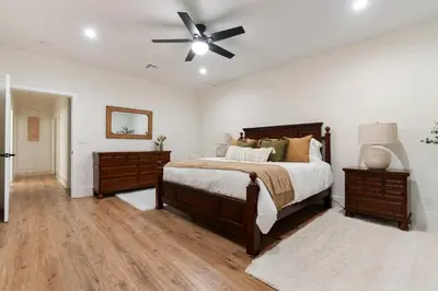 a bedroom with a bed and a ceiling fan at Luxury Oasis Compound with Hot Tub with 3 Homes in Escondido