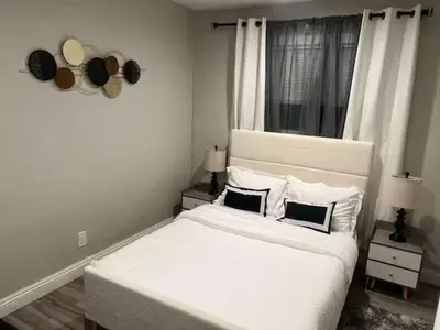 a bedroom with a large white bed with two pillows at Exotic Home Rexview by SD Stay in San Diego
