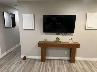 a room with a table and a television on a wall at Exotic Home Rexview by SD Stay in San Diego
