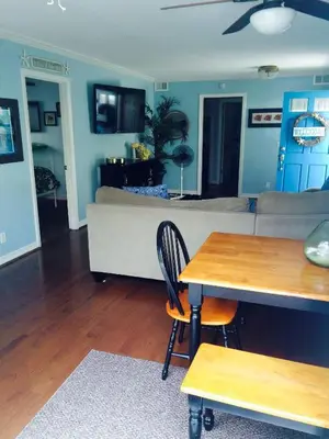a living room with a couch and a table at 6BR Beach House w/ Bikes/Fire pit/BBQ/Easy Parking in Newport Beach