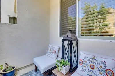 a porch with a chair and a window at Walk to Public Transit Oceanside Home with Balcony in Oceanside