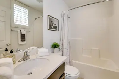 a white bathroom with a sink and a toilet at Walk to Public Transit Oceanside Home with Balcony in Oceanside