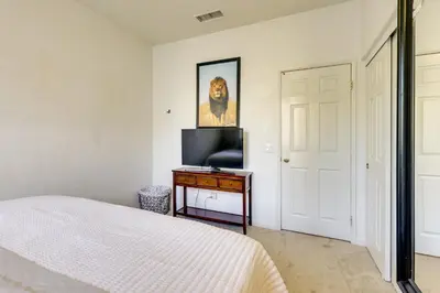 a bedroom with a bed and a television on a table at Walk to Public Transit Oceanside Home with Balcony in Oceanside