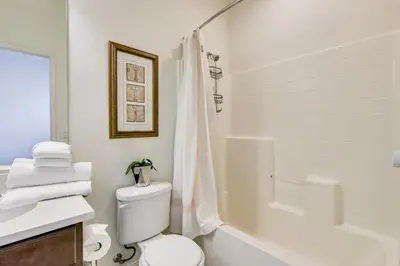 a white bathroom with a toilet and a shower at Walk to Public Transit Oceanside Home with Balcony in Oceanside