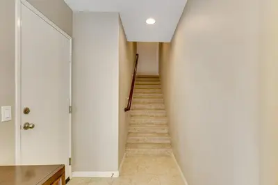 a hallway with white walls and a stairway at Walk to Public Transit Oceanside Home with Balcony in Oceanside