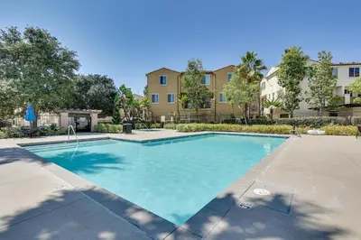 a swimming pool in a courtyard with a building at Walk to Public Transit Oceanside Home with Balcony in Oceanside
