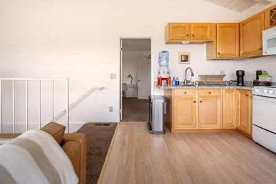 a kitchen with wooden cabinets and white appliances at North PB Gem Close to the Beach in San Diego