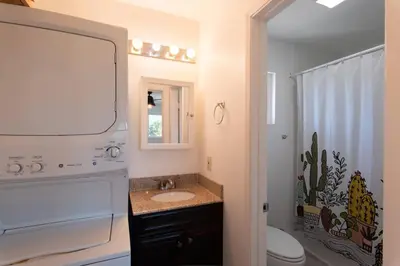 a bathroom with a sink and a toilet and a mirror at North PB Gem Close to the Beach in San Diego