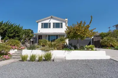a white house with a gravel driveway at North PB Gem Close to the Beach in San Diego