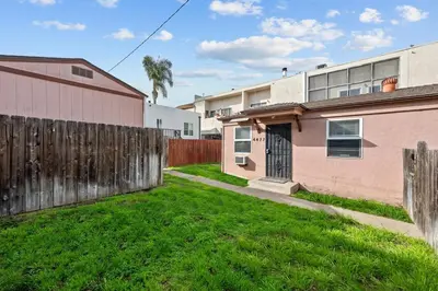 a yard with a fence and a house at Prime North Park Stay, Walk to Restaurants, Bars, and Breweries with Free Parking in San Diego