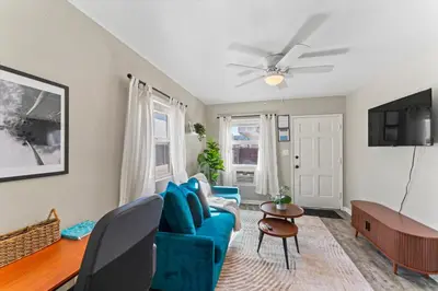 a living room with a blue couch and a ceiling fan at Stylish & Comfy Gem in North Park, Walk to Restaurants, Bars, and Breweries in San Diego