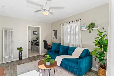 a living room with a blue couch and a table at Stylish & Comfy Gem in North Park, Walk to Restaurants, Bars, and Breweries in San Diego