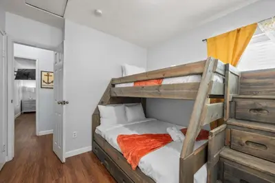 a bedroom with a bunk bed with an orange blanket at Modern Escape, Close to Zoo, Gaslamp and Beaches in San Diego