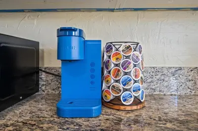a blue thermos on a counter next to a box of cupcakes at Modern Escape, Close to Zoo, Gaslamp and Beaches in San Diego