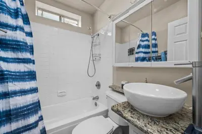 a bathroom with a sink and a toilet and a shower at Modern Escape, Close to Zoo, Gaslamp and Beaches in San Diego