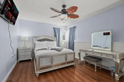 a bedroom with a bed with a dresser and a desk at Modern Escape, Close to Zoo, Gaslamp and Beaches in San Diego