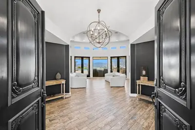 a living room with a couch and a chandelier at Private Gated 6BR Luxury Estate, Gym, Lake View in Escondido