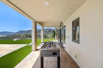 a room with a ping pong table on the side of a building at Private Gated 6BR Luxury Estate, Gym, Lake View in Escondido