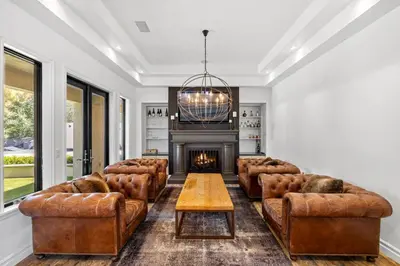 a living room with leather furniture and a fireplace at Private Gated 6BR Luxury Estate, Gym, Lake View in Escondido