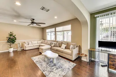 a living room with a couch and a tv at Spacious Menifee Home with Patio, 9 Mi to Lake! in Menifee