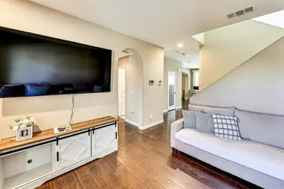 a living room with a large flat screen tv at Spacious Menifee Home with Patio, 9 Mi to Lake! in Menifee