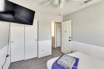 a bedroom with a bed and a flat screen tv at Spacious Menifee Home with Patio, 9 Mi to Lake! in Menifee