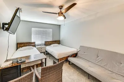 a living room with two beds and a couch at Spacious Menifee Home with Patio, 9 Mi to Lake! in Menifee