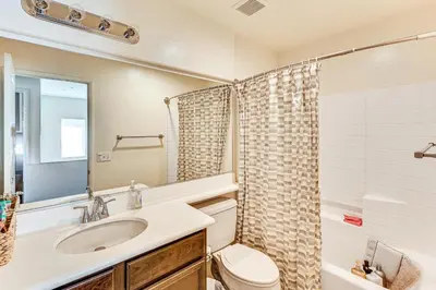 a bathroom with a sink and a toilet and a mirror at Spacious Menifee Home with Patio, 9 Mi to Lake! in Menifee