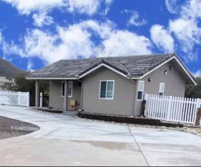 a house with a white fence in front of it at Alpine's Gorgeous Guest Home in Alpine