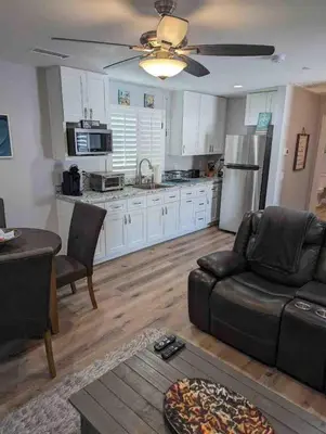 a living room with a couch and a kitchen at Alpine's Gorgeous Guest Home in Alpine