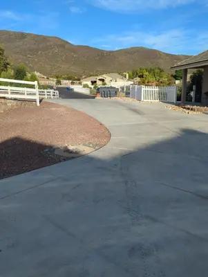 a concrete driveway with a white fence and a house at Alpine's Gorgeous Guest Home in Alpine