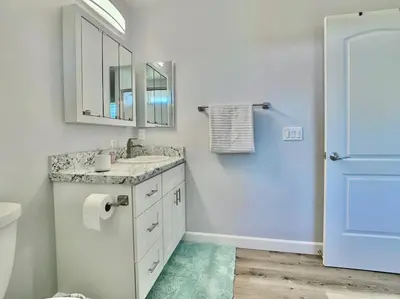 a bathroom with a sink and a mirror and a toilet at Alpine's Gorgeous Guest Home in Alpine