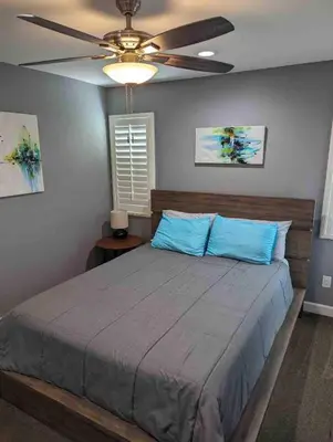 a bedroom with a bed and a ceiling fan at Alpine's Gorgeous Guest Home in Alpine