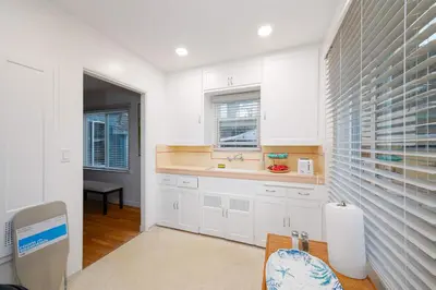 a kitchen with white cabinets and a sink at 10 Min to the Beach Colorful Home Huge Yard in San Diego