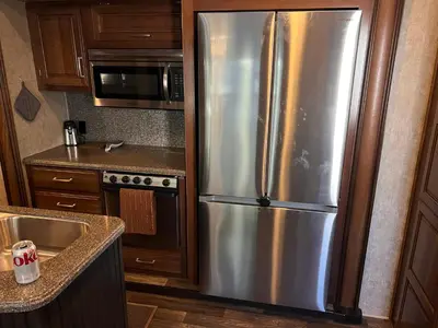 a kitchen with a stainless steel refrigerator and a microwave at Rancho CA 78 in Aguanga