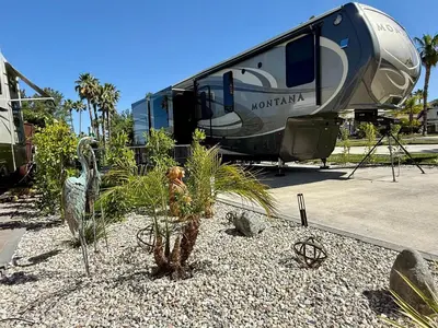 a rv parked in a lot with a palm tree at Rancho CA 78 in Aguanga