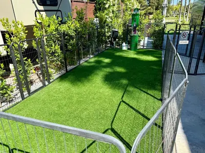 a fence with green grass in a yard at Rancho CA 78 in Aguanga