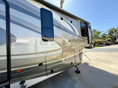 a rv parked in a parking lot with its door open at Rancho CA 78 in Aguanga