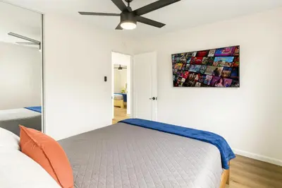 a bedroom with a bed and a ceiling fan at Sunny Coastal Escape Large 3BR Home Sleeps 8 in San Diego