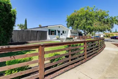 a wooden fence in front of a house at Sunny Coastal Escape Large 3BR Home Sleeps 8 in San Diego