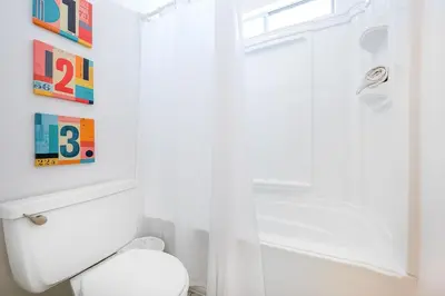 a bathroom with a white toilet and a shower at Newport Beach Simplicity II in Newport Beach