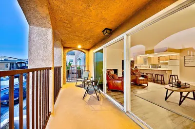 a large balcony with a living room and a kitchen at Newport Beach Simplicity II in Newport Beach