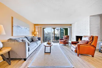 a living room with a couch and a fireplace at Newport Beach Simplicity II in Newport Beach