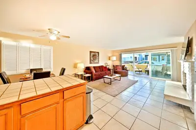 a kitchen and living room with a couch and a table at Newport Beach Simplicity in Newport Beach