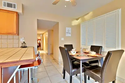 a kitchen and dining room with a table and chairs at Newport Beach Simplicity in Newport Beach