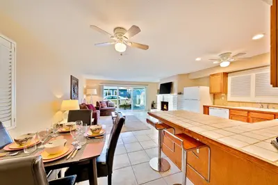 a kitchen and living room with a table and chairs at Newport Beach Simplicity in Newport Beach